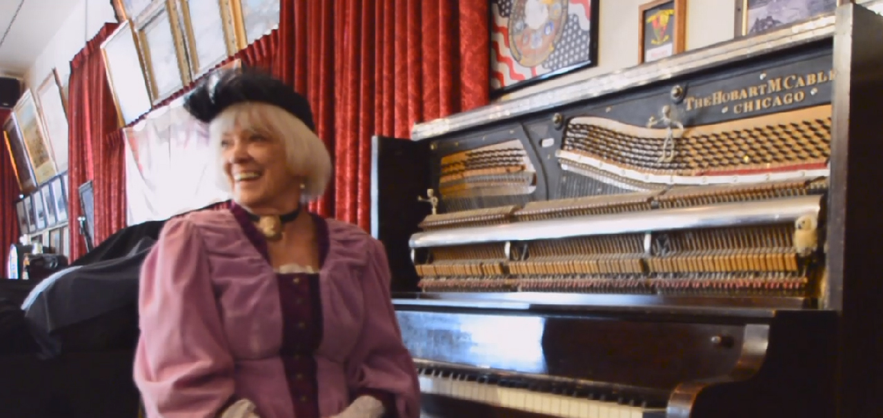 Squeek Steele at an upright piano inside the Bucket of Blood Saloon